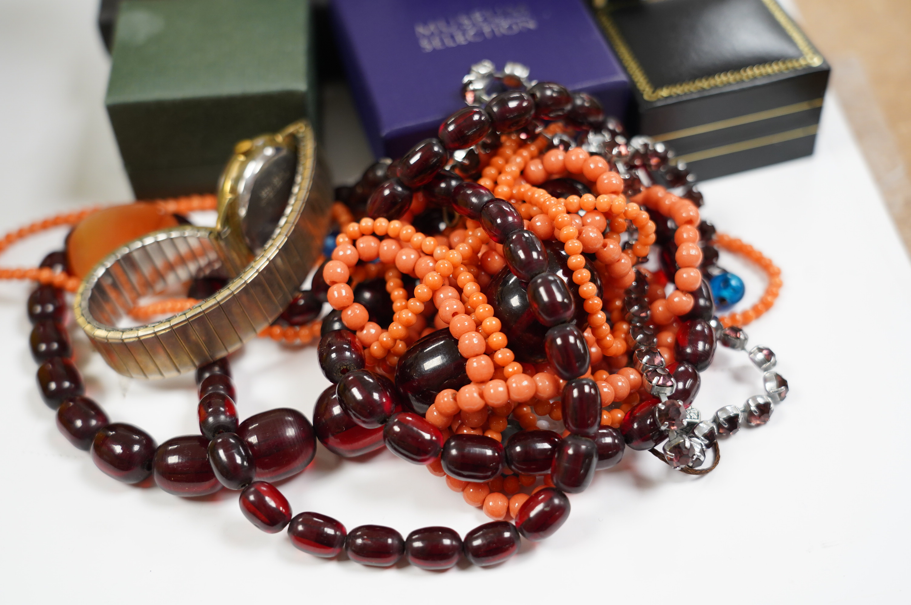 Assorted costume jewellery including simulated cherry amber necklace and simulated coral bead necklace. Condition - poor to fair